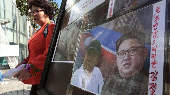A sign shows images of Kim Jong-un, right, and his older brother Kim Jong-nam during a campaign to improve human rights condition in North Korea, in Seoul, South Korea last week.