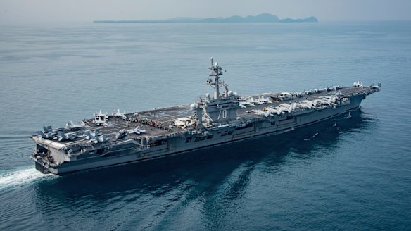 In this Saturday, April 15, 2017 photo released by the U.S. Navy, the aircraft carrier USS Carl Vinson transits the Sunda Strait between the Indonesian islands of Java and Sumatra.