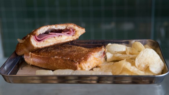Toasted reuben with pastrami, sauerkraut, gruyere cheese and Russian dressing – and potato crisps on the side.