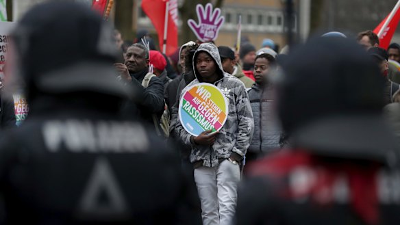 Police officers observe a protest rally against a party convention of anti-migration party the Alternative for Germany, AfD, party in Hannover, Germany.