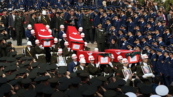 Soldiers carry the coffins of eight of the 28 victims of Wednesday's bomb attack in Ankara.