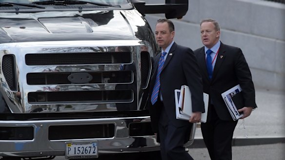 Donald Trump's chief of staff Reince Priebus, left, and incoming press secretary Sean Spicer, right, walk to their bus at the Eisenhower Executive Office Building in Washington.