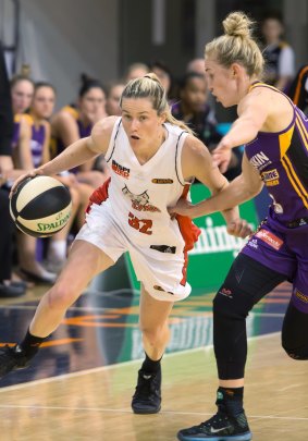 Perth Lynx's Sami Whitcomb dribbles with Melbourne Boomers' guard Brittany Smart defending her closely. 