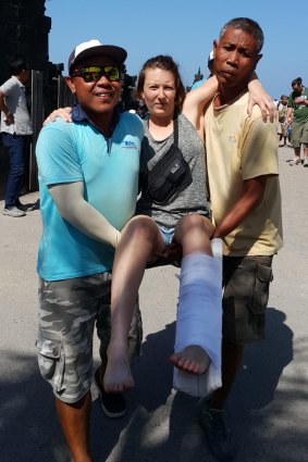 One woman who was a passenger on the ferry is carried by Wahana Bali's staff.
