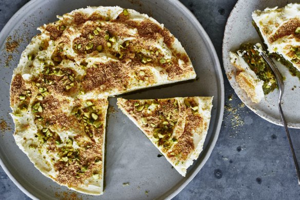 Mafroukeh cake topped with clotted cream, toasted kishk and pistachios.