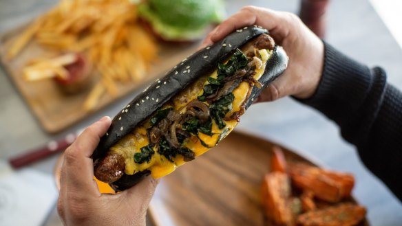 Heidelburger's Salsiccia, an Italian sausage, with sauteed silverbeet, caramelised onion and scarmorza cheese in a charcoal bun.