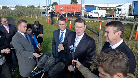 Former premier Denis Napthine, flanked by federal Infrastructure Minister Jamie Briggs and former transport minister Terry Mulder spruiking the East West Link.