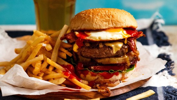 Corner-shop burgers are built so impossibly tall with all the other toppings – pineapple, bacon, beetroot, egg, lettuce, tomato and onion – no actual human could ever fit them in their mouth. But we love them.
