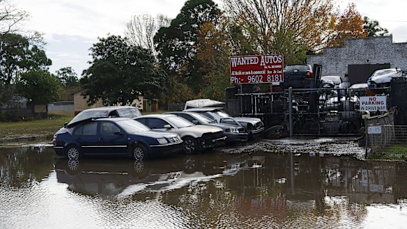 Cars trapped in floodwaters on Newbridge Road, Milperra.