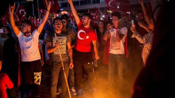 People cheer as they burn an effigy of  Fethullah Gulen at a rally in Taksim Square in Istanbul, Turkey.