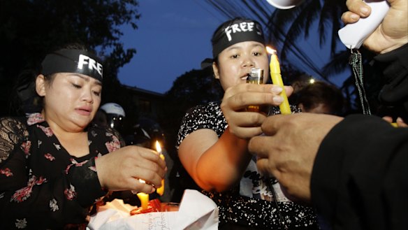 Human rights activists light candles  at Monday's protest in Phnom Penh. Human Rights Watch and Cambodian human rights groups have decried increasing persecution of dissent in the country.