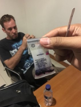Joshua James Baker in custody in Bali with the alleged drugs found on him.