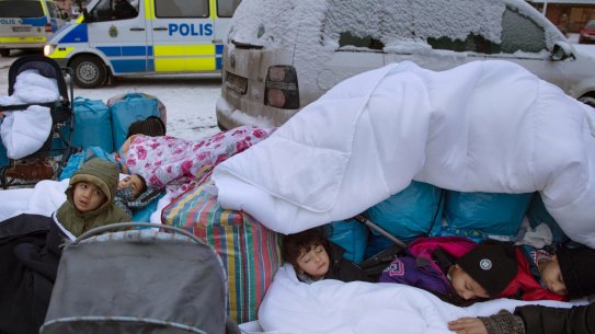 Migrant children from Syria sleep outside the Swedish Migration Board, in Marsta, Sweden. 