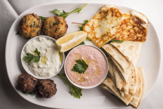 The mezze plate for two includes garlicky tzatziki and salmon-pink taramasalata.
