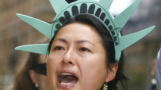 A woman dressed as the Statue of Liberty protests against US President Donald Trump's travel ban in Sydney.