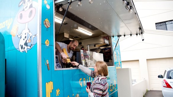 Say cheese: Beau Lange grills raclette cheese from his Dairy Extraordinary food truck in the Sydney suburb of Kingsgrove.