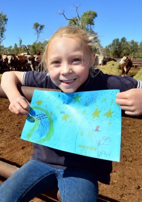 Bailey Brooks with her winning picture that will be painted across the rocket that delivers the satellite into outer space