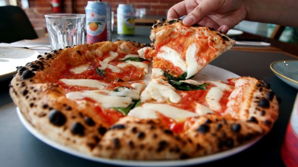 Puffy-crusted margherita pizza.