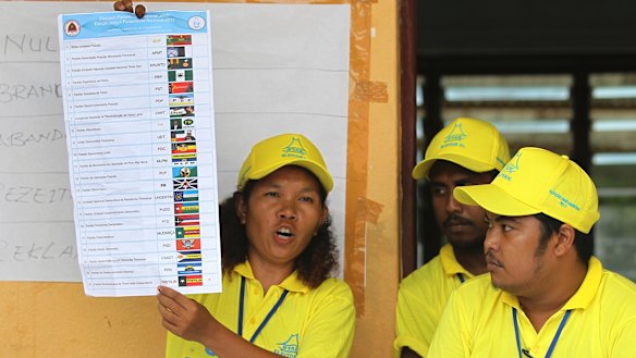 An electoral worker shows a ballot paper in Dili, East Timor, on Saturday.