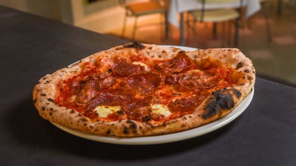 Napoli-style pizzas feature blousy crusts framing an arrangement of toppings. 