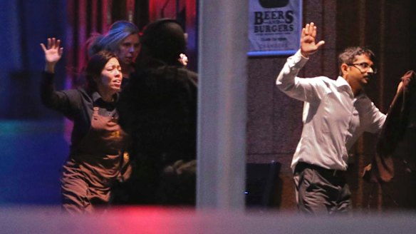 Hostages escape from the Lindt cafe during the siege.