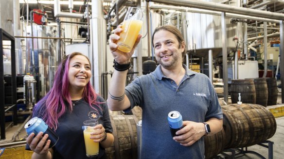 Hawkers Beer CEO Mazen Hajjar and staff member Yostina Askander enjoying a Hazy Pale Ale at the brewery in Reservoir, Melbourne.