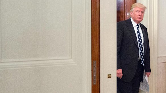 US President Donald Trump walks into the State Dining Room of the White House on Thursday.