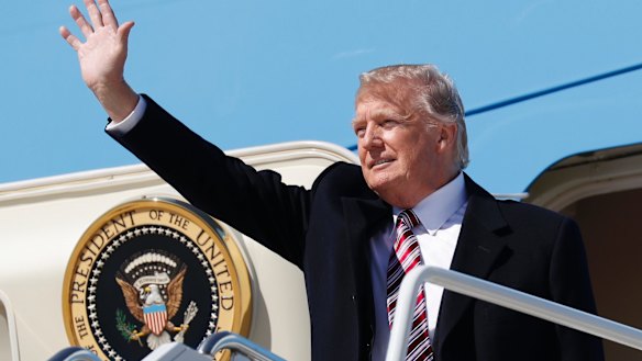 Donald Trump waves upon his arrival on Air Force One at Langley Air Force Base.