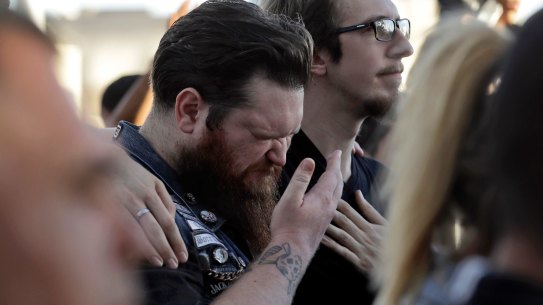 Sean Bolger is comforted by a friend during a vigil for the people killed in Las Vegas.