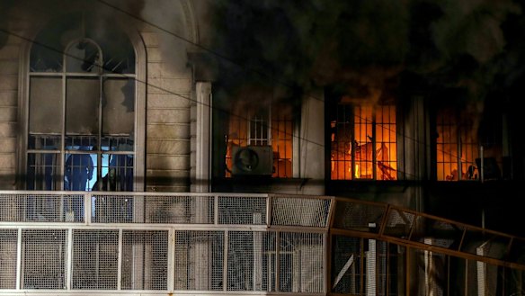 Smoke billows from the windows of the burning Saudi embassy in Tehran following a protest by Iranian activists.