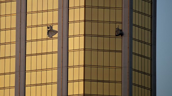 Drapes billow out of broken windows at the Mandalay Bay resort.