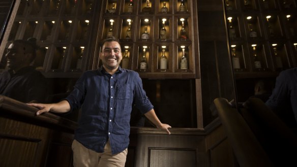 Mezcal fan Liber Osorio in front of the mezcal wall at his new bar Londres 126 in Sydney's CBD.