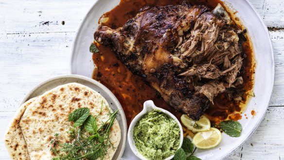 Whole roast lamb shoulder with Sichuan sauce, coriander and mint paste and sesame flatbread.