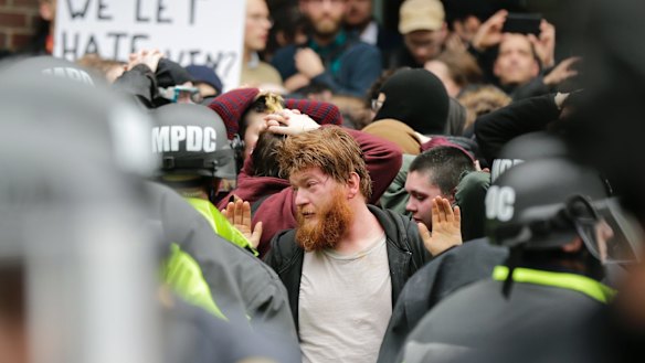 Protesters are isolated by police following the deployment of pepper spray in downtown Washington.