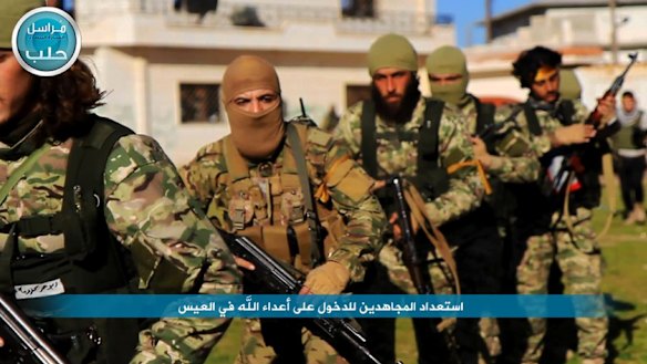 Fighters from the jihadist group Jabhat Fatah al-Sham marching toward the northern village of al-Ais in Aleppo province in April.