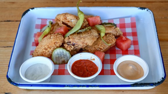 Fried chicken wings with pressed watermelon, chipotle aioli, pickles and tahini yoghurt.