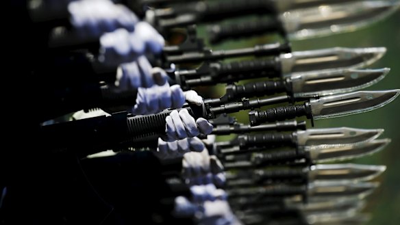 Soldiers of China's People's Liberation Army march with their weapons during a training session.