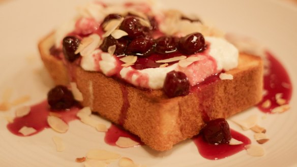 Sour cherries, buffalo yoghurt and toasted almond flakes on toast at Maillard Toast & Espresso Bar in North Fitzroy.
