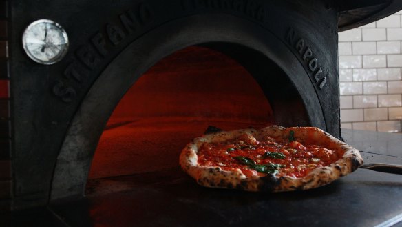 Pizza at Tartufo sliding out of a 485°C oven.