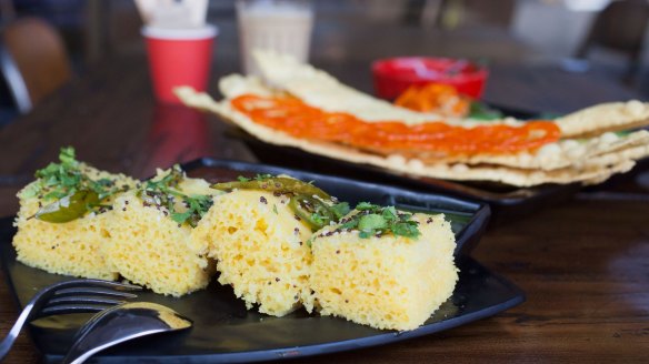 Haman dhokla, a steamed cake sprinkled with mustard seeds and curry leaves, at Chatkazz.