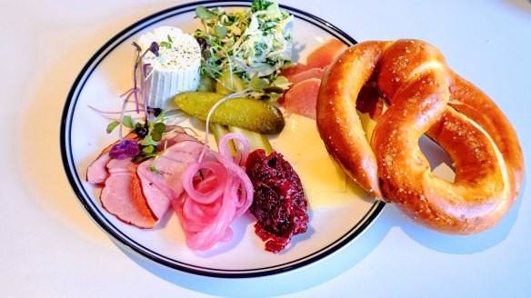 Austro's pretzel plate with cured meats, cheese and pickles.