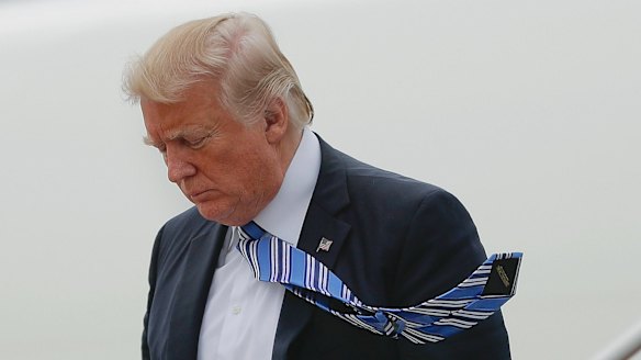 President Donald Trump walks down the stairs of Air Force One during his arrival at Andrews Air Force Base.