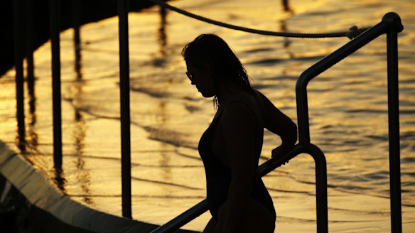 A swimmer gets an early start at Bondi as February looks like being among the city's hottest on record.