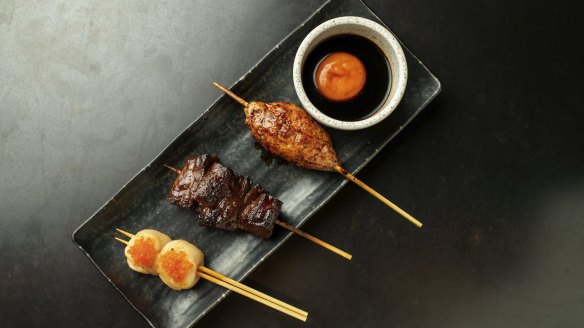 A platter with tsukune (chicken meatball), wagyu and scallop skewers.