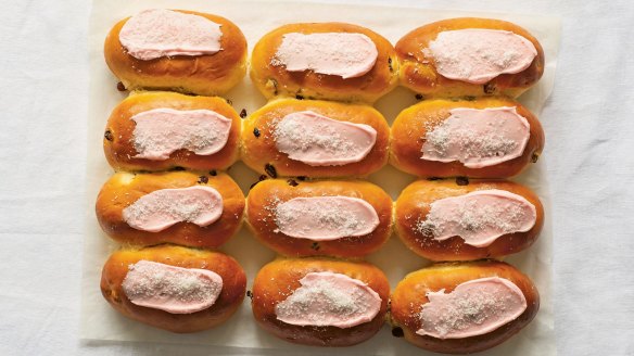 Finger buns decorated with pink icing and desiccated coconut.