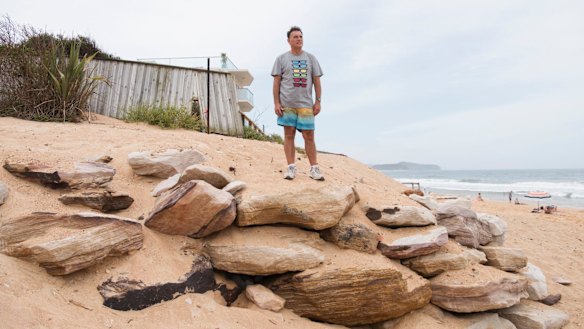 Collaroy resident Garry Silk standing on the site where the June east coast low tore away the dunes protecting his beachside home. A swimming pool lies beneath his feet, buried in the sea defence.