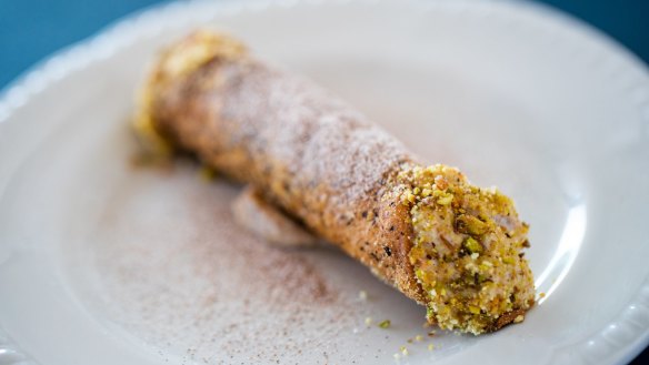 Wattleseed ricotta cannoli, a crisp, nutty tunnel filled with cream.