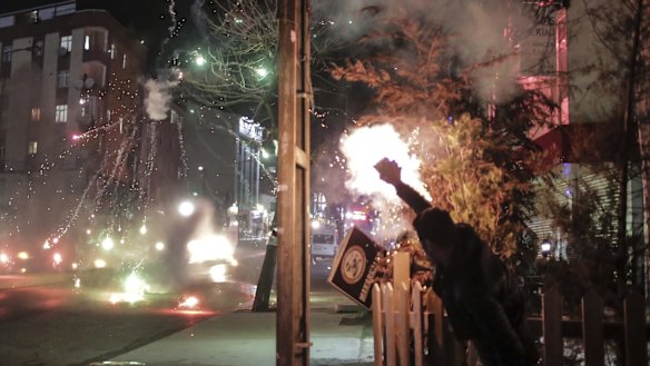 A pro-Kurdish protester launches firecrackers towards a Turkish police water cannon during clashes in Istanbul earlier this month. Turkey imposed curfews in mainly Kurdish towns and districts in December while its security forces battled militants linked to the Kurdistan Workers' Party, or PKK.