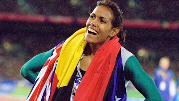 Cathy Freeman celebrates gold in the Womens 400m Final at the Sydney Olympic Stadium.
