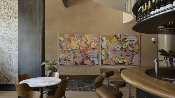 Diners are welcomed by a horseshoe bar and artwork by Gregory Hodge. 
